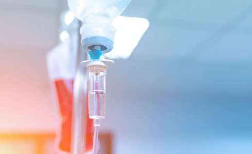 Close-up of an iv drip in a naturopathic medicine setting with a soft focus background.