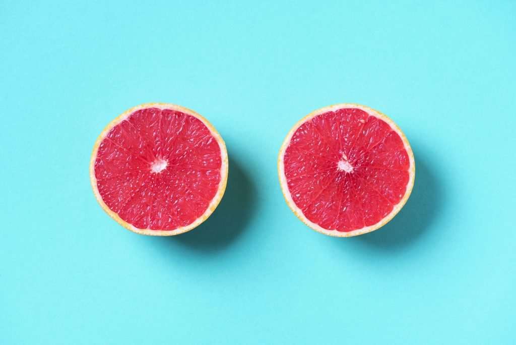 Two halves of a grapefruit on a blue background, symbolizing the meridian principles in functional medicine.