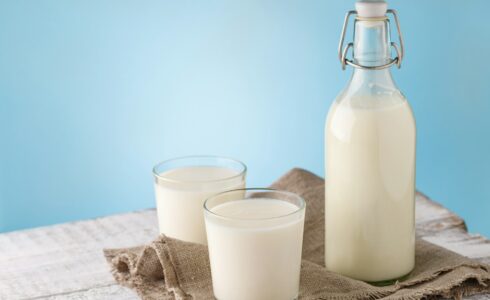 Bottle and glass with milk for lactose problems in functional medicine