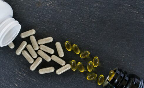 Top view of vitamin supplements on a black surface